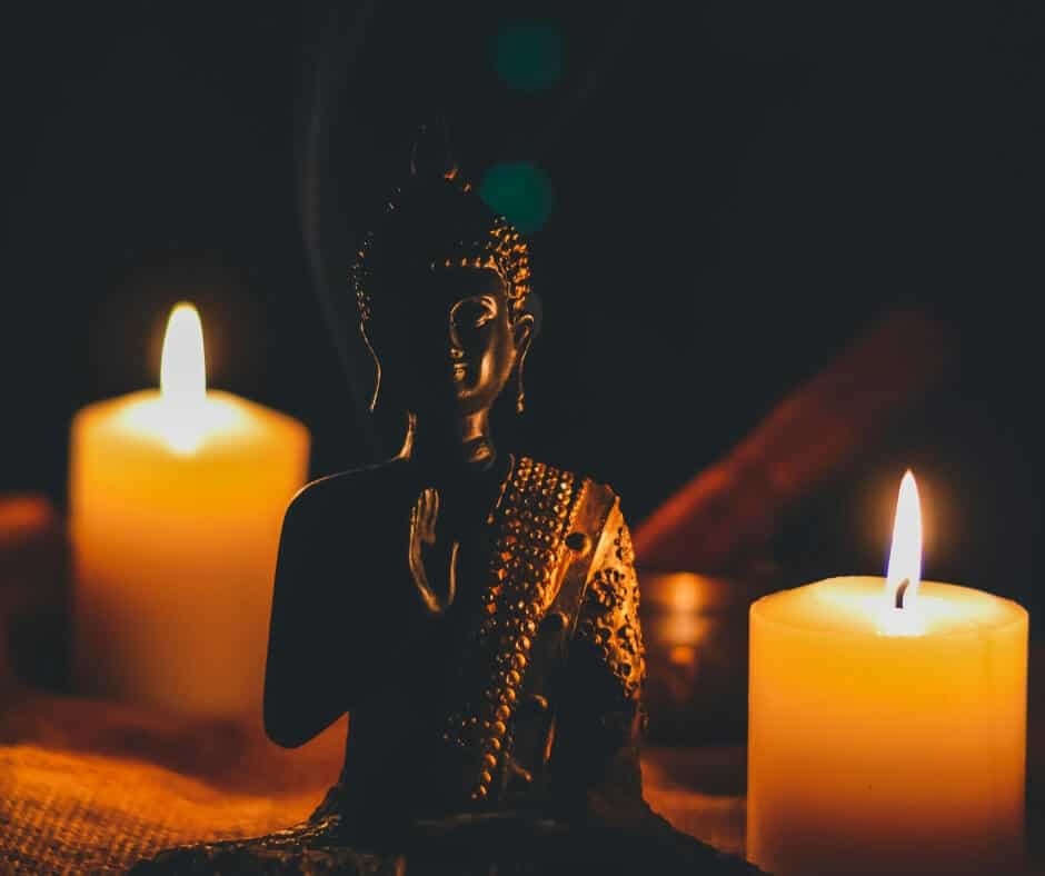 Buddha Statue between two candles