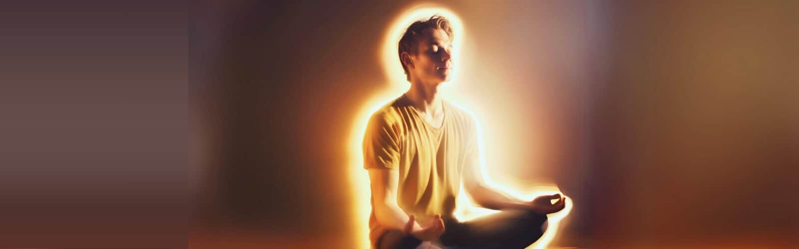 A person sits cross-legged, meditating with eyes closed and a warm, glowing light surrounding them.